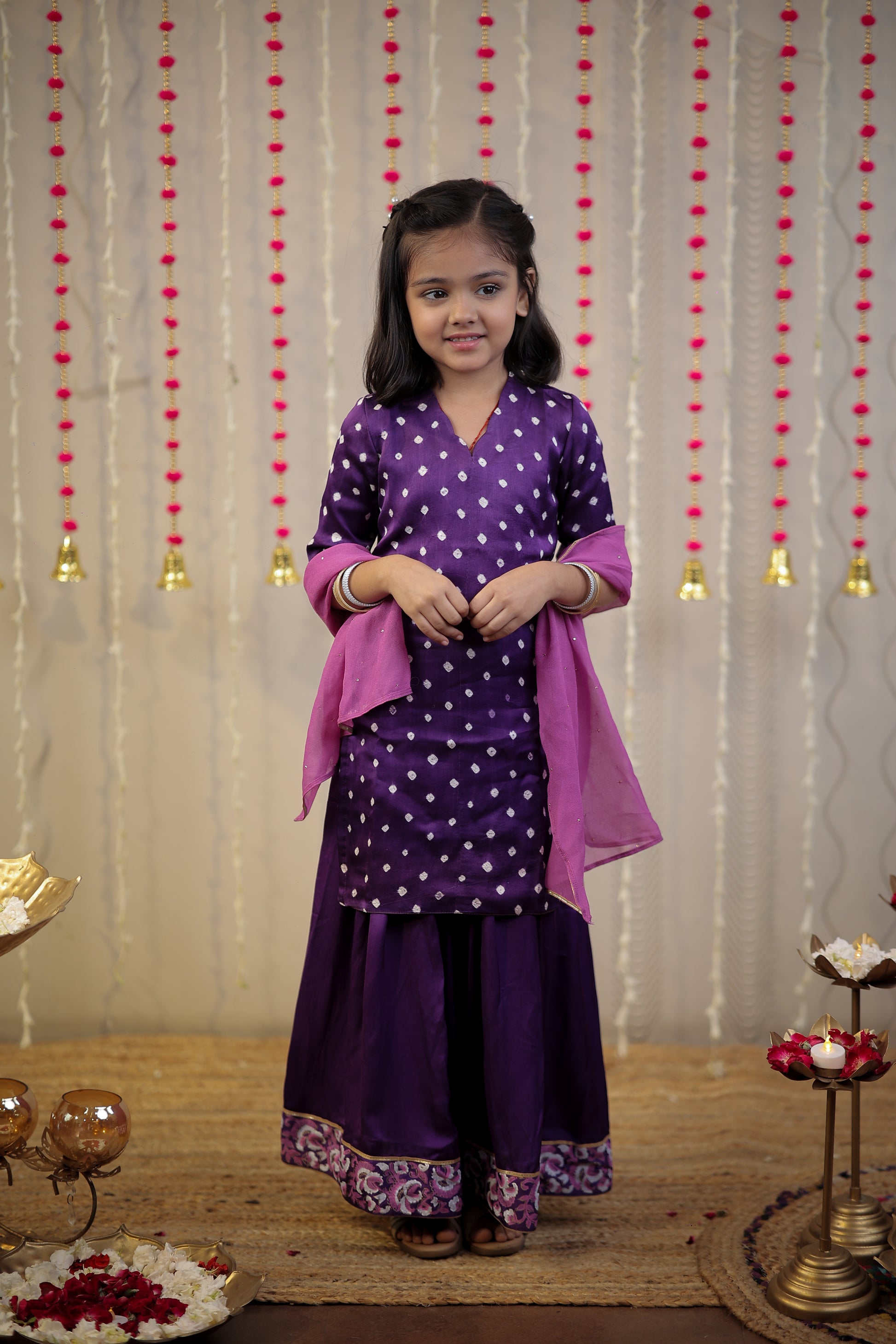 Purple Bandhej kurta with sharara set and dupatta.