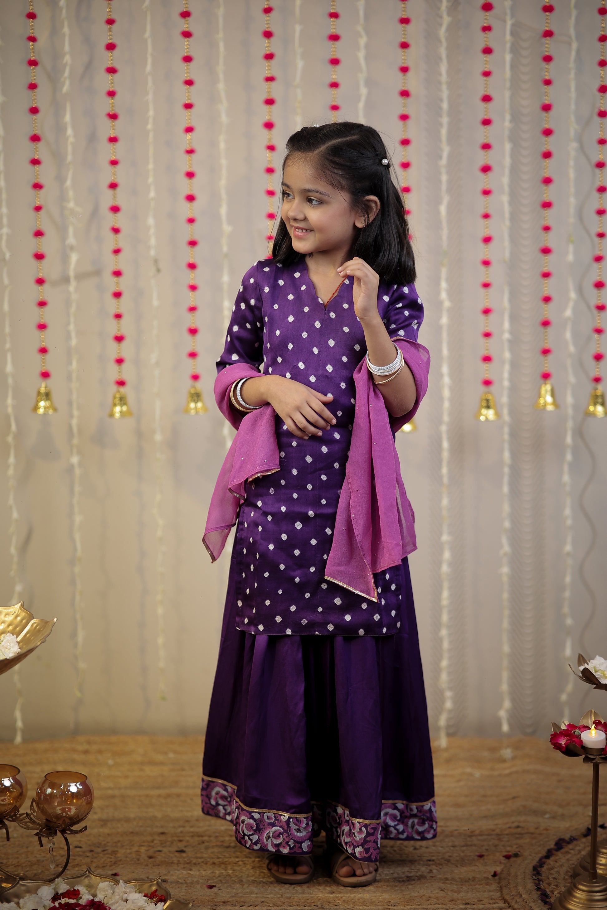 Purple Bandhej kurta with sharara set and dupatta.