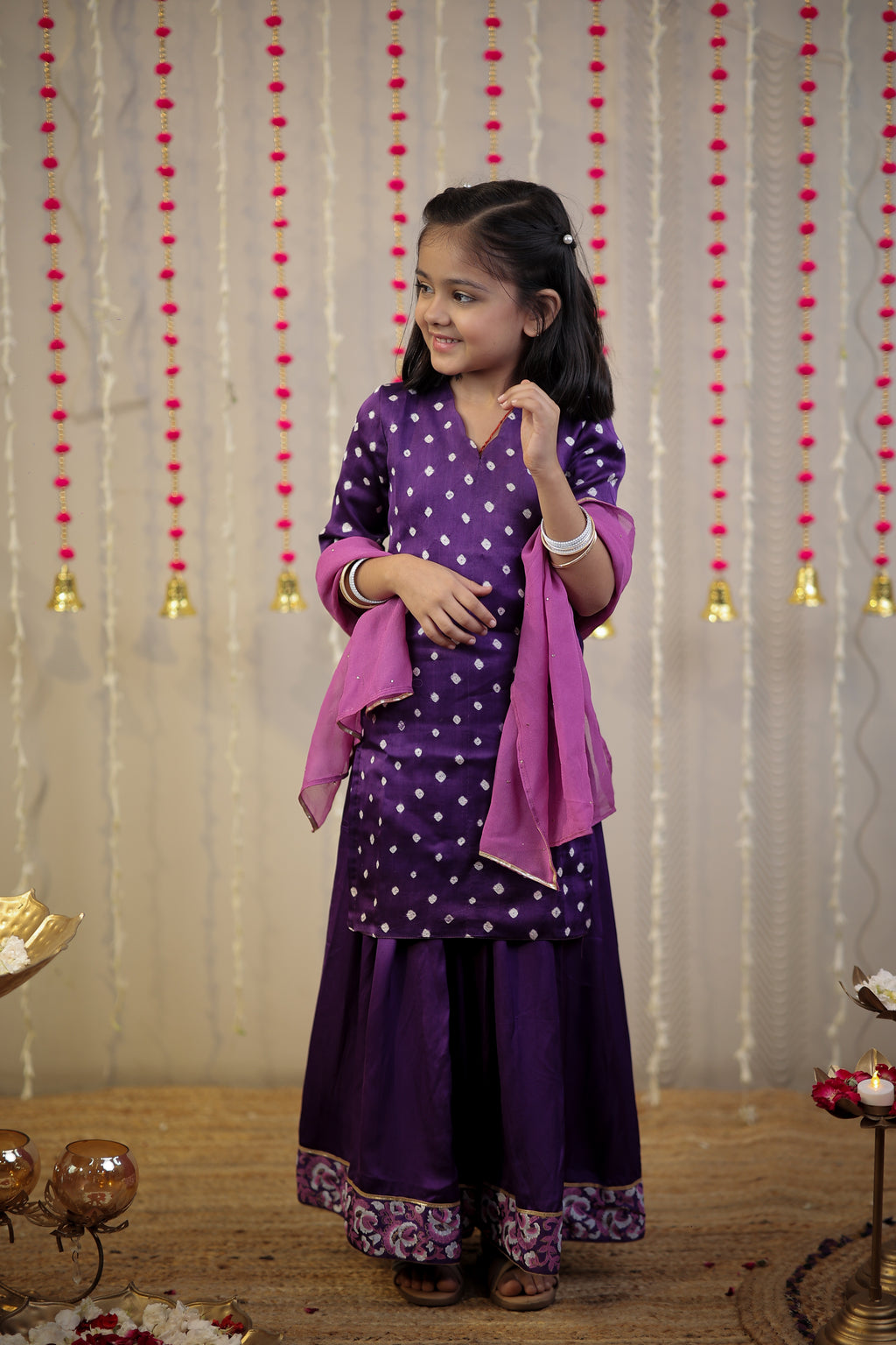 Purple Bandhej kurta with sharara set and dupatta.