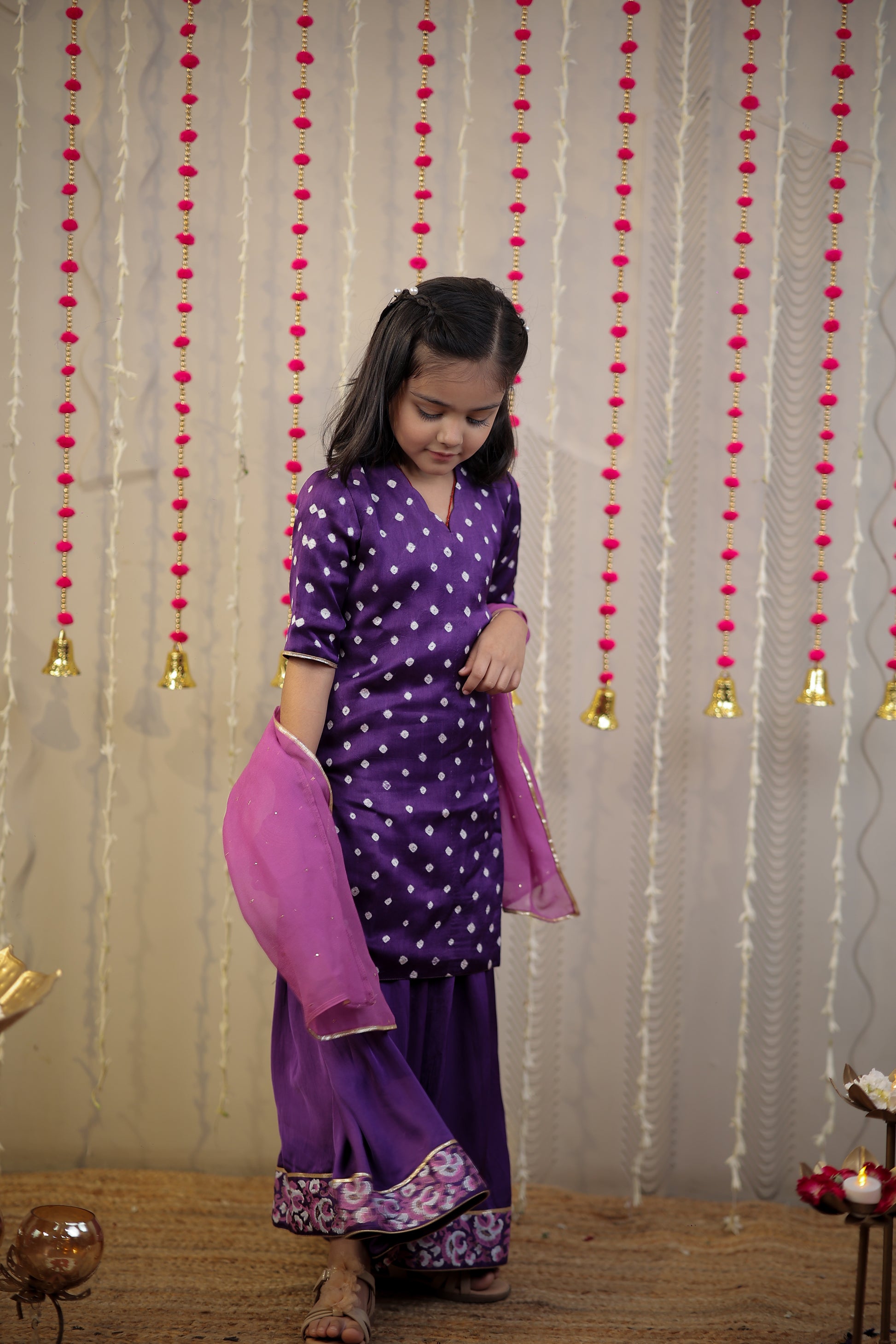 Purple Bandhej kurta with sharara set and dupatta.