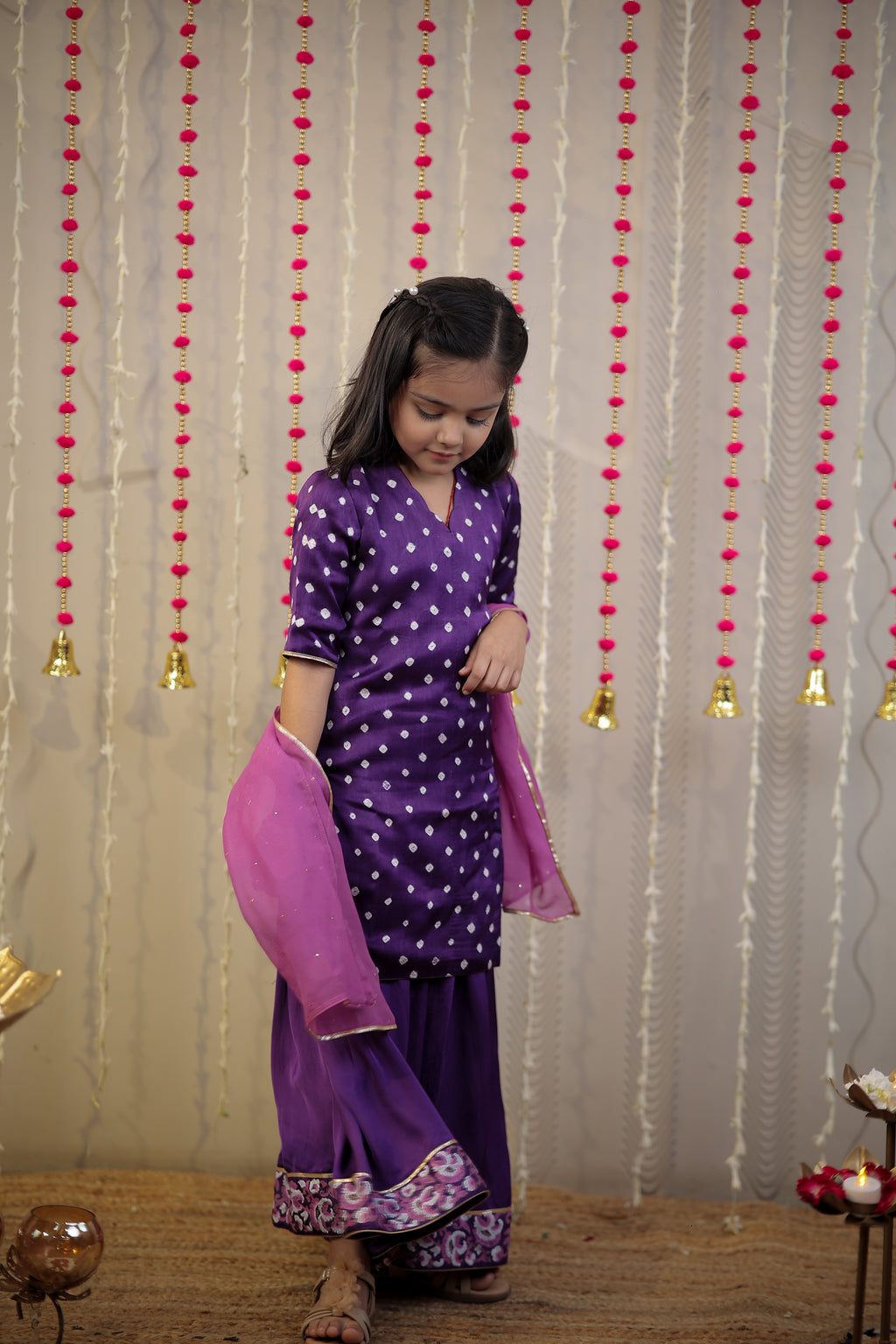 Purple Bandhej kurta with sharara set and dupatta.